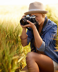 Image showing Woman, camera and photography with summer, vacation and holiday with wheat field and travel. Nature, photographer and outdoor with traveler blog and countryside with photo for adventure and journey