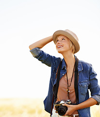 Image showing Woman, camera and thinking with travel, vacation and holiday with wheat field and plants. Nature, photographer and outdoor with traveler blog and countryside with photo for adventure and journey