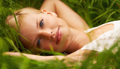Image showing Grass field, nature portrait and happy woman relax, smile or leisure for outdoor stress relief, wellness or park break. Freedom, spring face or forest girl enjoy fresh air, sunshine or rest on ground