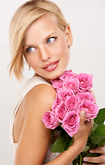 Image showing Flowers, bouquet and rose with woman in studio for floral, valentines day and romance gift. Plants, beauty and happy with face of female person on white background for elegant, love and present