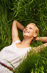 Image showing Grass field, happy and nature woman relax, smile or rest for outdoor stress relief, morning wellness or break. Freedom, happiness and person enjoy fresh air, summer or harmony on natural green lawn
