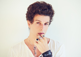 Image showing Cool, accessories or portrait of man in studio on a white background for fashion, swag or unique style. Jewelry, bracelet or rings on the fingers of a young male model for trendy or edgy expression