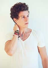 Image showing Thinking, accessories or cool man in studio on a white background for fashion, swag or unique style. Jewelry, bracelet or chain of a young punk male model for trendy, fancy or edgy expression alone