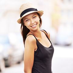 Image showing Woman, portrait and fashion or street travel style, summer look for weekend vacation. Female person, tourist and face hat for sunshine city road walking or outdoor adventure, relax or holiday clothes