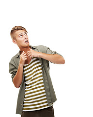 Image showing Fear, looking and a man on a white background with mockup for horror, scared and alarm. Young, expression and a person or guy with danger, terrified or afraid of spooky space on a studio backdrop