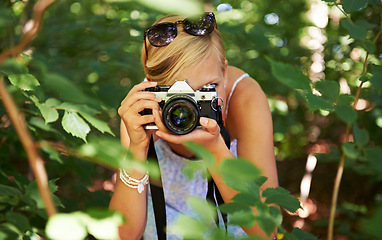 Image showing Camera lens, shooting and photographer with woman in forest for relax, memory and travel photography. Summer, trees and adventure with person in nature for vacation, holiday and environmental tourism