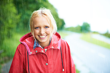 Image showing Woman, smile and raincoat in outdoor weather, wet and cold from rain, winter and nature. Happy female person, fashion and red jacket is stylish, rainfall and protection from water, face and portrait