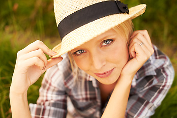 Image showing Smile, portrait and young woman in nature with a straw hat sitting in an outdoor garden for fresh air. Happy, fashion and female person from Australia in the forest, woods or field with casual style.