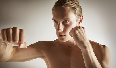 Image showing Fighting, conflict and shirtless with man, training and fitness on a white studio background. Person, guy and professional with exercise, practice for a match and muscle with workout and competition