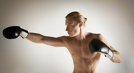 Image showing Fighting, boxing and shirtless with man, training and exercise with health on a studio white background. Person, guy and professional with competition, practice for a match and muscle with workout