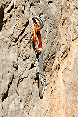 Image showing Rock, climbing and carabiner tools on mountain, boulder or cliff for safety in exercise. Metal, gear and secure bolt on rocks with outdoor training and adventure in nature with danger or risk