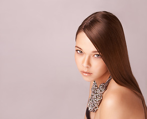 Image showing Cosmetics, portrait or woman with fashion, jewellery and hair care in studio for wellness and beauty. Person, face and skincare with natural glow, keratin or treatment on brown background with mockup