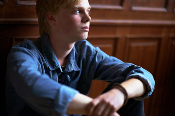 Image showing Thinking, depression and an unhappy boy student at school as an outcast feeling lonely in a classroom. Education, scholarship and a sad young child in a class looking bored while alone on campus