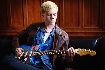 Image showing Music, artist and young man with guitar for artistic, creative and musical career with talent. Guitarist, musician and male person playing an electric string instrument for recording in a studio.