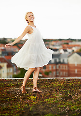 Image showing Woman, happiness and spinning on holiday, summer and outdoor for vacation, smiling and city. Wind, dancer and urban area for break, getaway and carefree on trip, dancing and amsterdam spring time