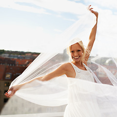 Image showing Portrait, smile and woman with chiffon in wind outdoor in city for summer, vacation or holiday. Happy, person and dress or fabric fly in urban town for freedom, beauty and elegant, fashion or style