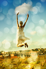 Image showing Woman, jumping and freedom with back, vacation, and outdoor for holiday, bokeh and city. Confident, energy and urban area for break, getaway and carefree with sky, barefoot and amsterdam spring time