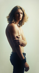Image showing Man, serious and shirtless in studio for fitness, wellness and body on white background. Model, person and topless for health, selfcare or healthy with fashion jeans, confidence and exercise