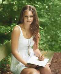 Image showing Park, portrait and a woman writing in her journal outdoor during summer for mental health or expression. Park, diary and idea with a young person in a green garden to relax for wellness or freedom