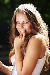 Image showing Portrait, flirt and a woman in the forest on a green background for freedom, travel or to relax. Face, smile and a happy young person in the countryside or woods for wellness or stress relief