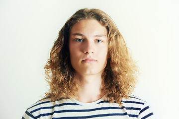 Image showing Long hair, man or fashion for portrait in a studio with hipster style clothing or shirt on white background. Face, person or headshot of young stylish gen z male model with cool confidence and pride