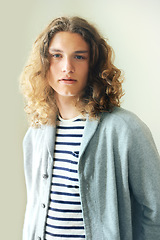 Image showing Long hair, man or fashion for portrait with hipster style clothing or shirt on white background. Face, person or headshot of young stylish gen z male model with cool confidence and pride in studio