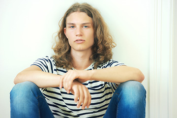 Image showing Man, face and hair with beauty, trendy hipster with curly hairstyle and wellness. Young, gen z portrait and casual clothes with curls, style and serious in tshirt, cool person and relax with fashion