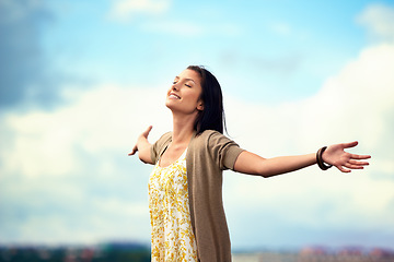 Image showing Woman, arms spread and happy on rooftop, adventure and freedom on trip to Norway, joy and sky background. Female person, vacation and relax or positive for getaway, energy and stretching in holiday