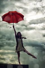 Image showing Woman, balance and umbrella on rooftop for weather, adventure and freedom on trip, sky and insurance. Female person, vacation and security for getaway, peace and ballet pose on holiday to Croatia