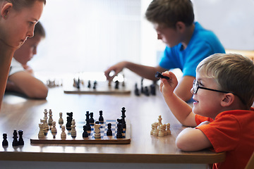 Image showing Students, chess and playing in a classroom, conversation and thinking with solution, problem solving and competition. Youth, group or boys with tournament, board game and strategy with skills or talk