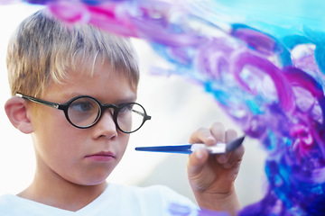 Image showing Boy painting on glass, brush and creating artwork with glasses, education and learning. Person, child and kid with art, student and teaching with development, childhood and creativity with an artist