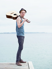 Image showing Lake, nature and portrait of man with guitar, inspiration on journey, freedom and outdoor vacation. Artist, musician or guitarist with creative holiday, music and travel adventure with calm water.