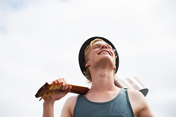 Image showing Freedom, sky and man with guitar, smile and inspiration in nature for talent, journey and vacation. Artist, musician or guitarist with creative thinking, music and travel adventure with happy holiday