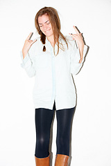 Image showing Fashion, rock sign and woman on a white background with punk hand gesture, signal and emoji. Confidence, attitude and face of isolated person in trendy clothes, casual outfit and style in studio