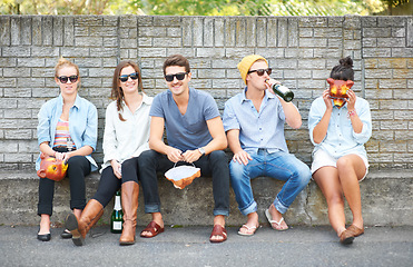 Image showing Social, portrait and friends on a bench in public for drinks, conversation and bonding on the weekend. Happy, group and people in the city for alcohol, communication and together for society