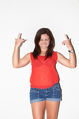 Image showing Fashion, rock sign and confident woman on a white background with hand gesture, signal and emoji. Culture, attitude and isolated person in trendy clothes, casual outfit and style for punk in studio