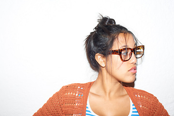 Image showing Face, vision and glasses with the attitude of a woman in studio isolated on a white background for style. Fashion, thinking and eyewear with a confident young person on space in a trendy outfit