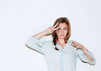 Image showing Beauty, peace sign and portrait of woman on a white background with confidence, hand gesture and emoji. Cosmetics, fashion and isolated person in trendy clothes, casual outfit and style in studio