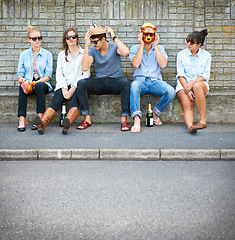 Image showing Party, friends and people with animal mask for fashion, bond and drink alcohol in city. Group, sunglasses and dress up in street, stylish men and hipster women sitting outdoor together for Halloween