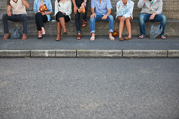 Image showing Low, street and legs of people in the city for bonding, social and community event. Urban, together and friends or a group sitting on the sidewalk of the road for solidarity, party or society