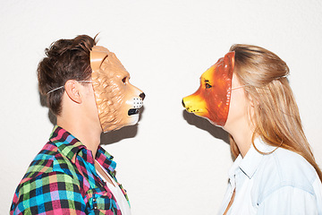 Image showing Animal mask, party and a couple on a white background for fun, bonding or comedy. Funny, character and a man and woman with equipment for a comic date, social or at a halloween event together