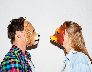 Image showing Animal mask, funny and a couple on a white background for fun, bonding or comedy. Party, character and a man and woman with equipment for a comic date, social or at a halloween event together