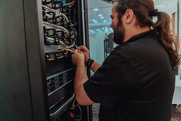 Image showing Close up of technician setting up network in server room