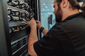 Image showing Close up of technician setting up network in server room