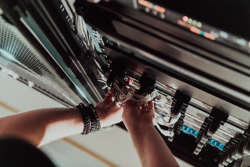 Image showing Close up of technician setting up network in server room