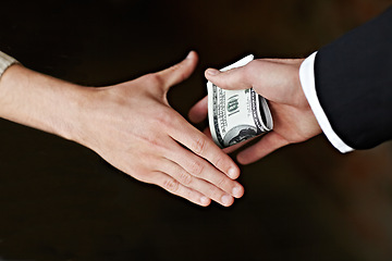 Image showing Hands, bribe and cash for payment, deal with handshake, corruption and crime opportunity with dark background. People, businessman or corporate scam with money laundering and professional fraud