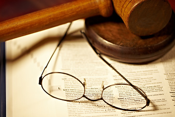 Image showing Table, law and a report, glasses and gavel for a court decision, notes or a justice report. Closeup, desk and paperwork or a dictionary for legal knowledge, courtroom words or a crime defense