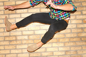 Image showing Fun, air and legs of a person on a wall for jumping, dance or action in the city. Energy, shoes and a man with speed, crazy activity and movement for urban culture, playful and enjoying weekend