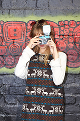 Image showing Woman, fashion and photographer camera on brick background or street art, trendy style or artist. Female person, clothes and picture for hipster outfit outdoor or creative vision, vintage or graffiti