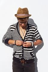 Image showing Man, fashion and hipster or white background for button trend, cool outfit or glasses eyewear. Male person, clothes style and confidence look or funky hat as studio mockup space, summer in Europe